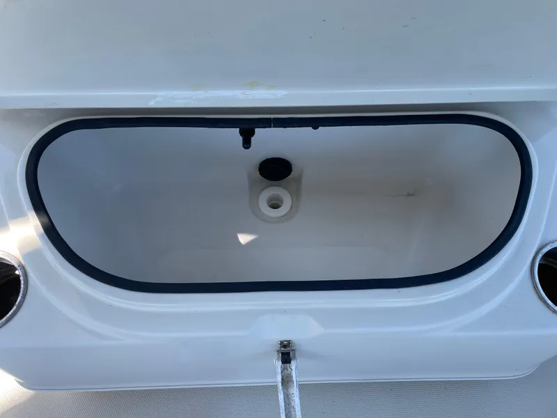 Slide: The Image of Open storage compartment on 2014 Triton 240 LTS Pro boat. - 12
