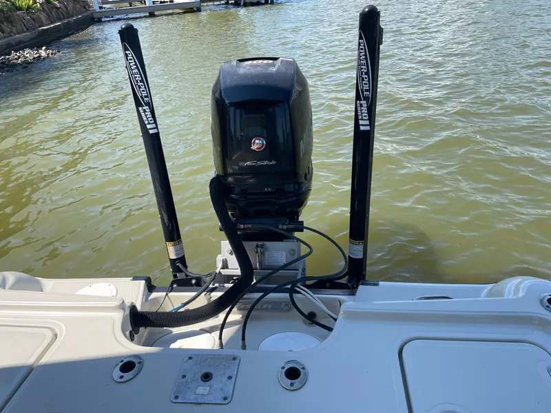 Slide: The Image of 2014 Triton 240 LTS Pro boat with motor and Power-Pole anchors on water. - 17