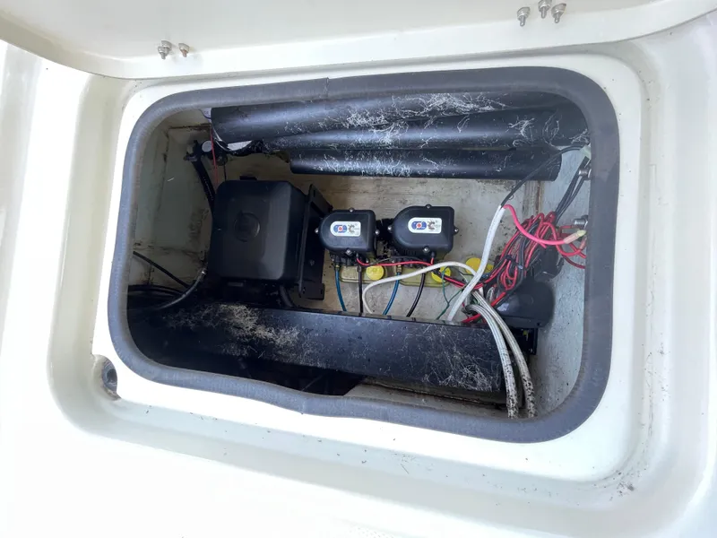 Slide: The Image of 2014 Triton 240 LTS Pro boat compartment with wiring and components. - 19