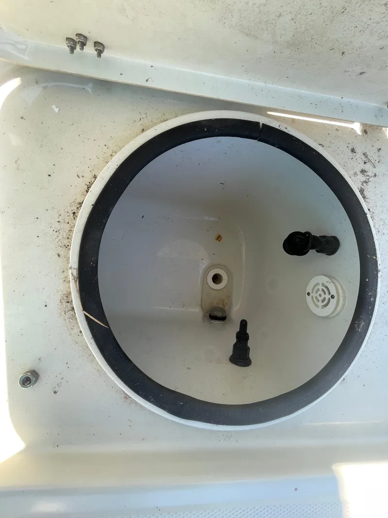 Slide: The Image of 2014 Triton 240 LTS Pro livewell interior with plumbing fixtures. - 20