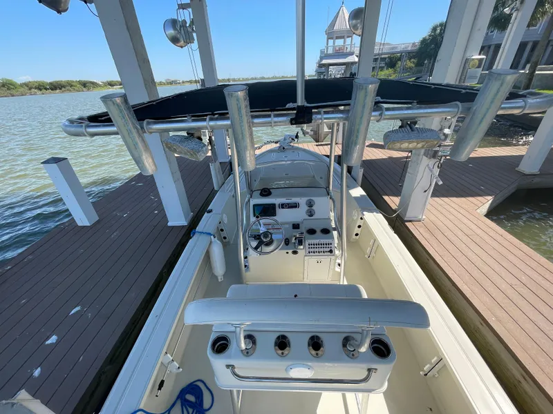 Slide: The Image of 2014 Triton 240 LTS Pro boat interior with console and rod holders. - 22