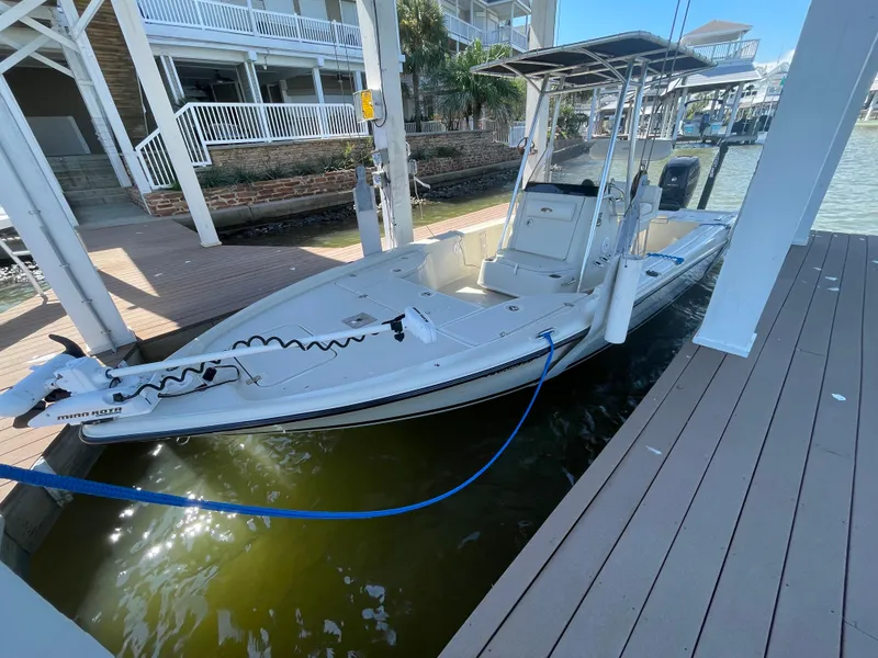 Slide: The Image of 2014 Triton 240 LTS Pro boat docked in marina, side view. - 24