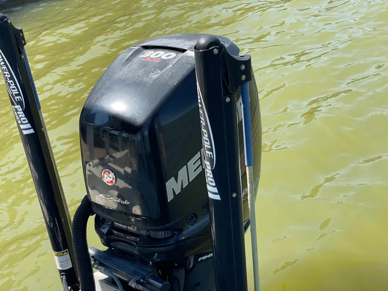 Slide: The Image of 2014 Triton 240 LTS Pro boat engine on water. - 25