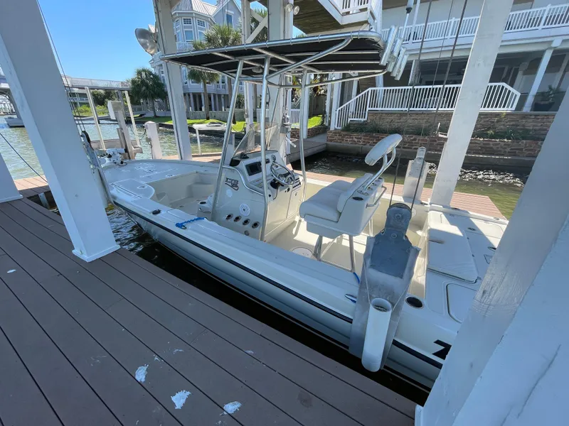 Slide: The Image of 2014 Triton 240 LTS Pro boat docked near waterfront homes. - 26