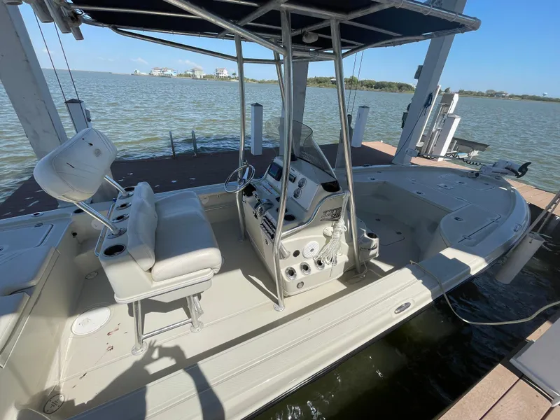 Slide: The Image of 2014 Triton 240 LTS Pro boat docked by the water. - 9