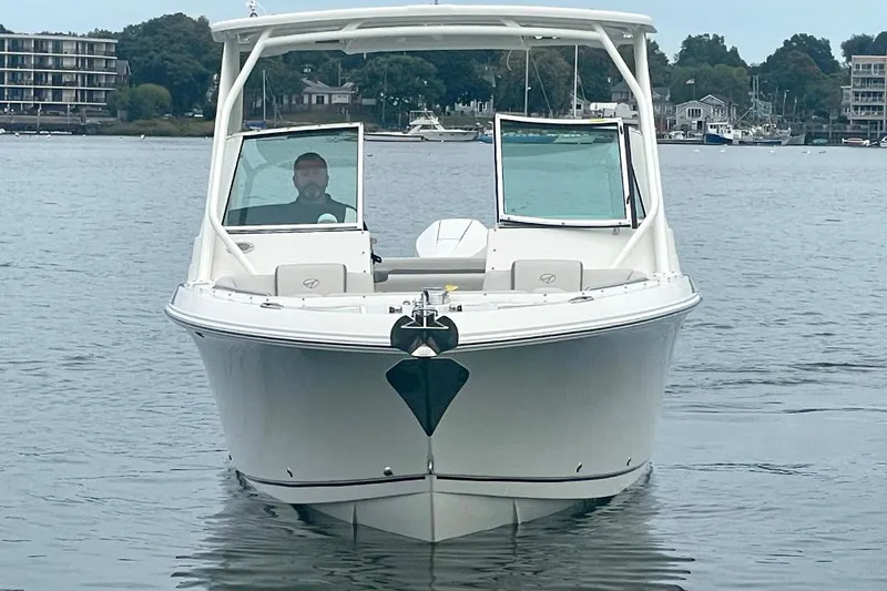 Slide: The Image of 2025 Sailfish 245 DC boat on calm water, front view. - 4