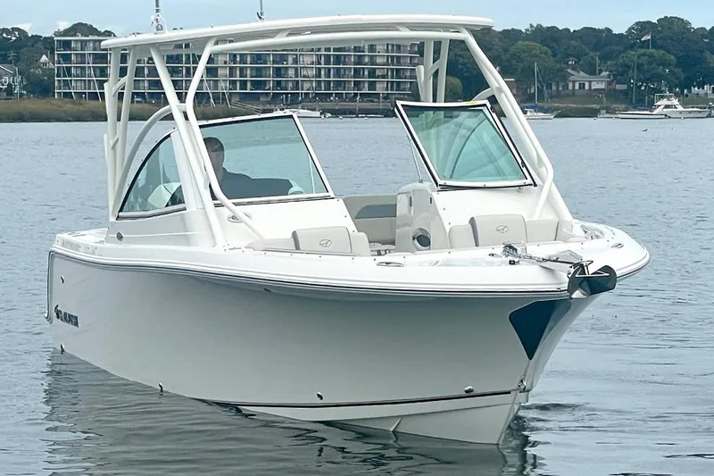 Slide: The Image of 2025 Sailfish 245 DC boat on calm water, modern design, open cockpit. - 6