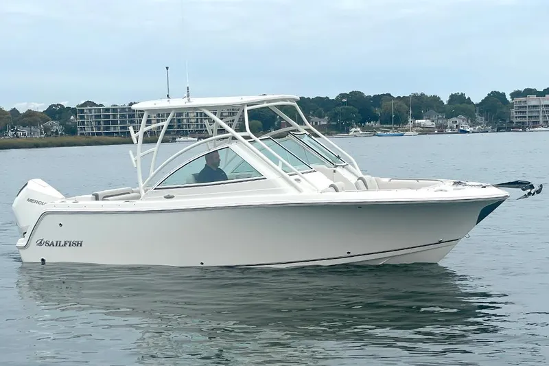 Slide: The Image of 2025 Sailfish 245 DC boat on calm water, side view. - 7