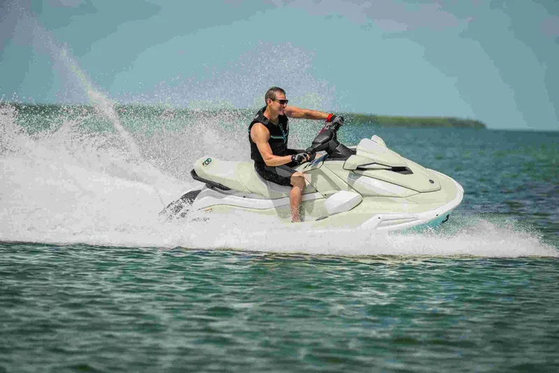 Slide: The Image of 2025 Waverunner VX Cruiser HO A jet ski speeding on open water. - 4