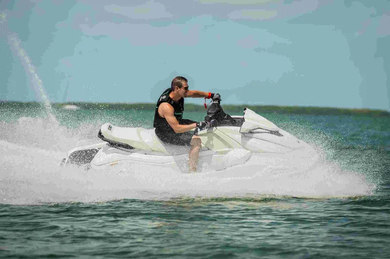 Slide: The Image of Man riding 2025 Waverunner VX Cruiser HO A jet ski on open water. - 7
