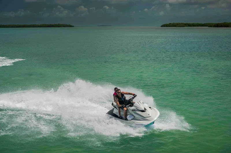 Slide: The Image of 2025 Waverunner VX CRUISER HO A jet ski on turquoise water, two riders enjoying speed. - 9
