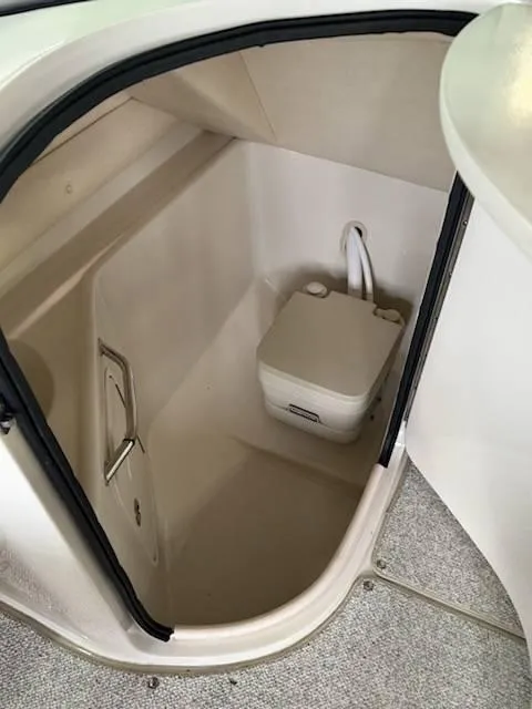 Slide: The Image of 2005 Sea Ray 240 Sundeck boat interior with portable toilet. - 10