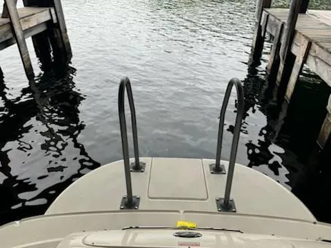 Slide: The Image of 2005 Sea Ray 240 Sundeck boat docked by wooden piers. - 4