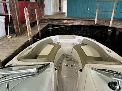 Slide: The Image of 2005 Sea Ray 240 Sundeck boat docked in a wooden marina. - 6