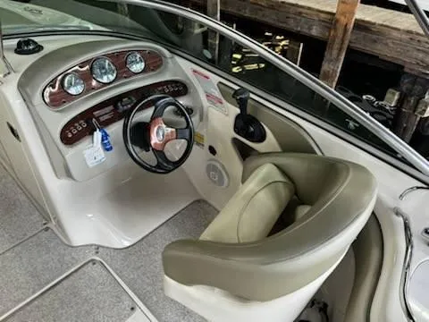 Slide: The Image of 2005 Sea Ray 240 Sundeck boat interior with steering wheel and dashboard. - 7