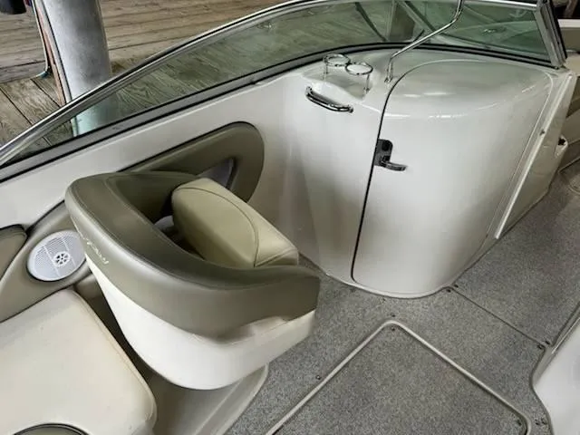 Slide: The Image of 2005 Sea Ray 240 Sundeck interior with seating and cup holders. - 8