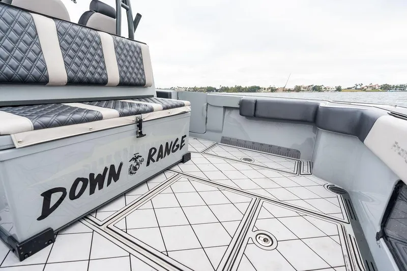 Slide: The Image of 2020 Front Runner 39 CC boat interior with quilted seating and "Down Range" text. - 11
