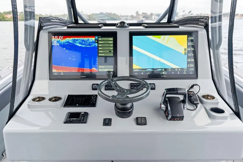 Slide: The Image of 2020 Front Runner 39 CC boat dashboard with dual navigation screens and steering wheel. - 16