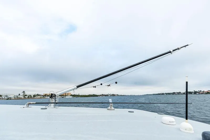 Slide: The Image of 2020 Front Runner 39 CC boat with fishing outriggers on a calm water backdrop. - 27