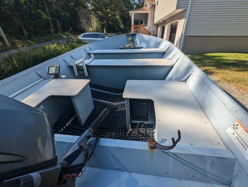 Slide: The Image of 2010 G3 Guide V16 boat with open deck, parked near a house. - 10