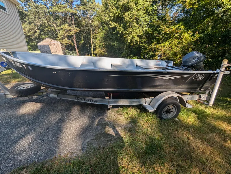 Slide: The Image of 2010 G3 Guide V16 boat on trailer, parked outdoors in a sunny setting. - 3