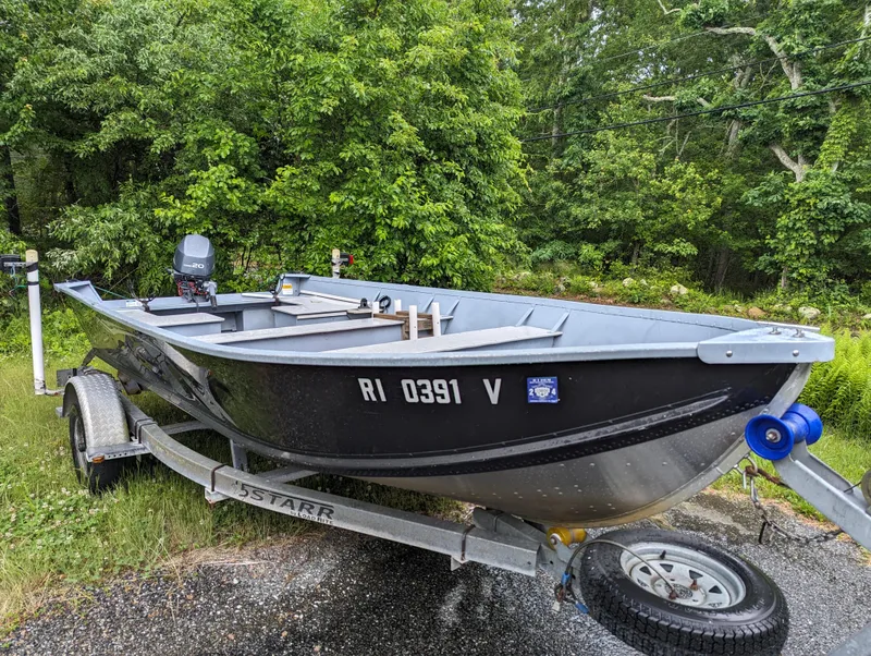 Slide: The Image of 2010 G3 Guide V16 boat on trailer in wooded area. - 5