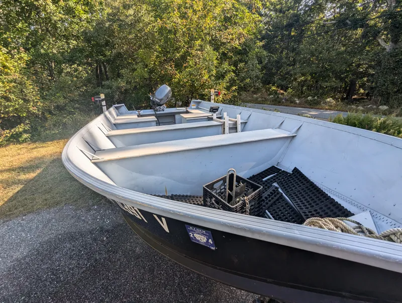 Slide: The Image of 2010 G3 Guide V16 boat on trailer, surrounded by trees. - 7