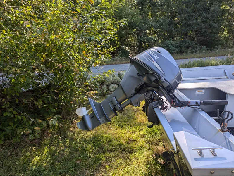 Slide: The Image of 2010 G3 Guide V16 boat with Yamaha outboard motor in a grassy area. - 9