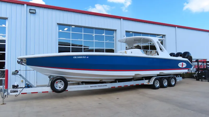 Slide: The Image of 2016 Cigarette 39 GTS boat on trailer, parked outside a building. - 3