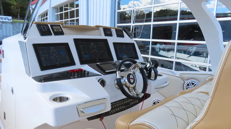 Slide: The Image of 2016 Cigarette 39 GTS boat dashboard with advanced navigation screens and luxurious seating. - 9