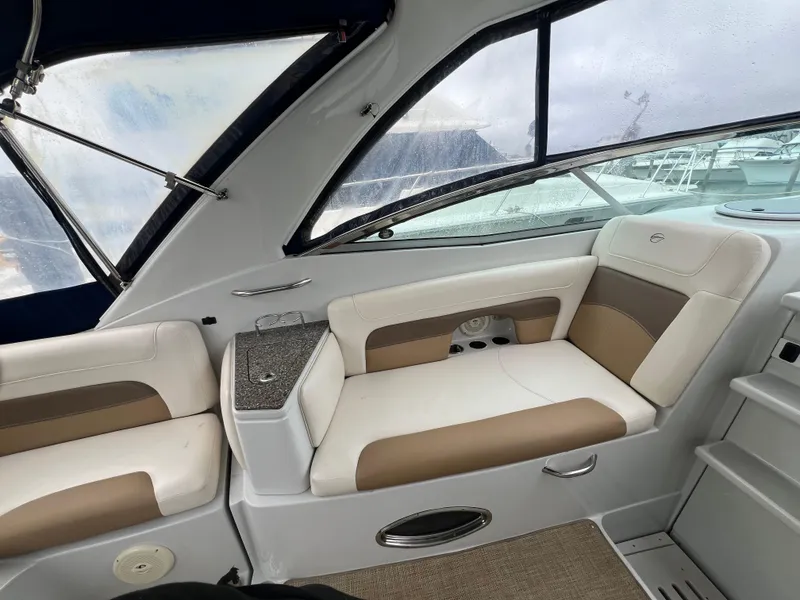 Slide: The Image of Interior of 2014 Crownline 294 CR boat with beige and white seating. - 12