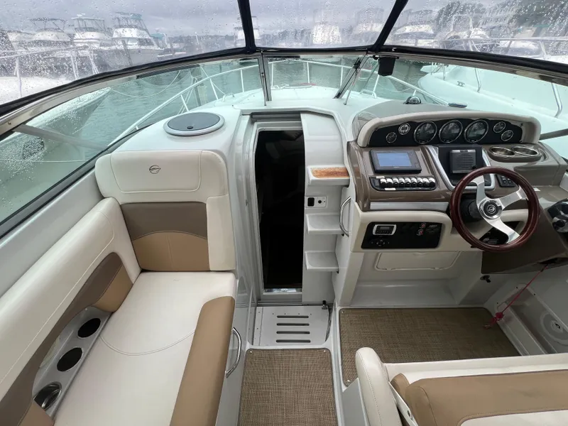 Slide: The Image of Interior of 2014 Crownline 294 CR boat with helm and seating area. - 15