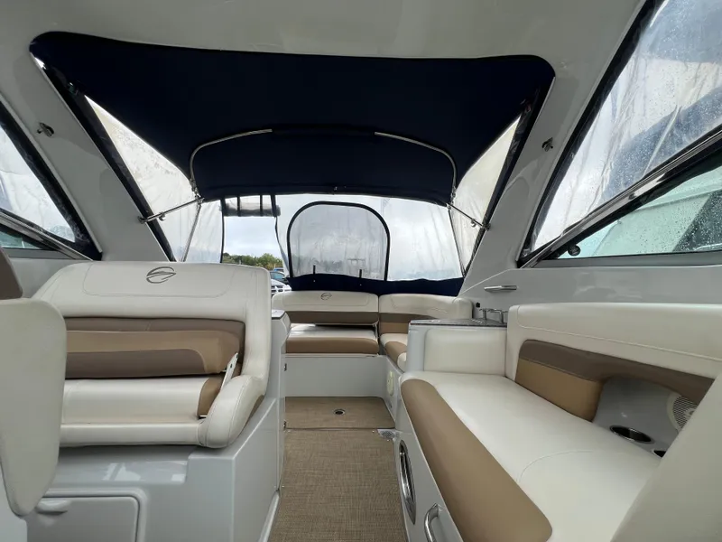 Slide: The Image of Interior of 2014 Crownline 294 CR boat with beige and white seating. - 26