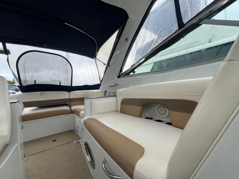Slide: The Image of 2014 Crownline 294 CR boat interior with beige and white seating. - 27