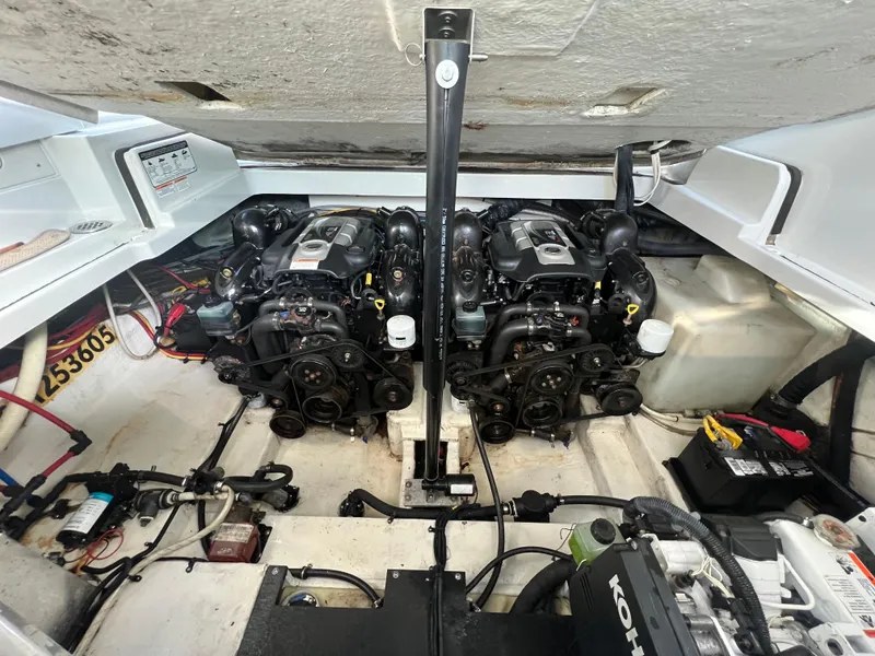 Slide: The Image of Engine compartment of a 2014 Crownline 294 CR boat, featuring dual engines and mechanical components. - 3