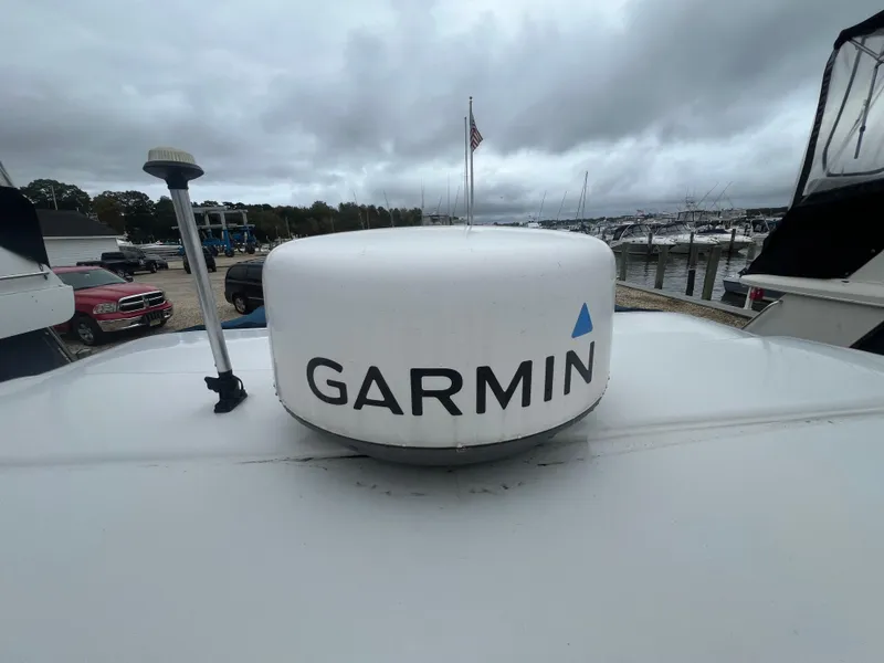 Slide: The Image of Garmin radar on 2014 Crownline 294 CR boat, docked at marina under cloudy sky. - 31