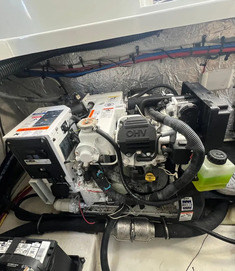 Slide: The Image of Engine compartment of a 2014 Crownline 294 CR boat, showcasing mechanical components. - 32