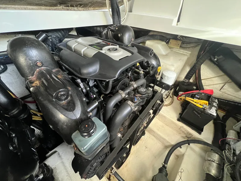 Slide: The Image of Engine compartment of a 2014 Crownline 294 CR boat, showcasing detailed mechanical components. - 35