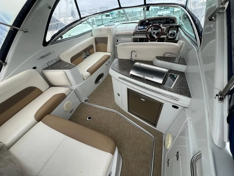Slide: The Image of 2014 Crownline 294 CR boat interior with seating and kitchenette. - 4