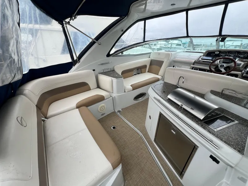 Slide: The Image of Interior of 2014 Crownline 294 CR boat with seating and kitchenette. - 5