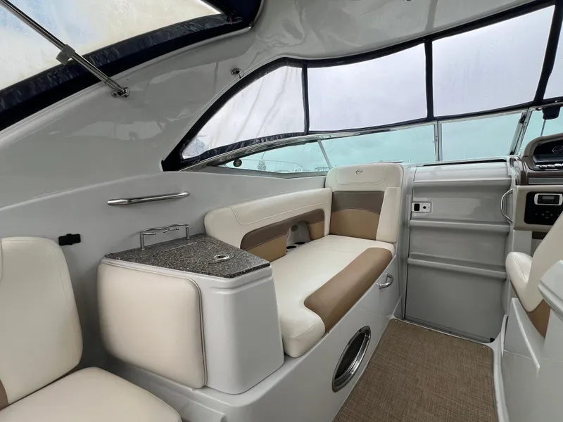 Slide: The Image of 2014 Crownline 294 CR boat interior with beige seating and modern design. - 7