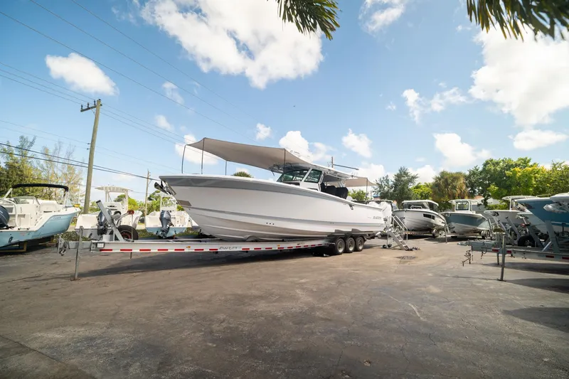 Slide: The Image of 2024 Blackfin 400CC boat on trailer under clear blue sky. - 12