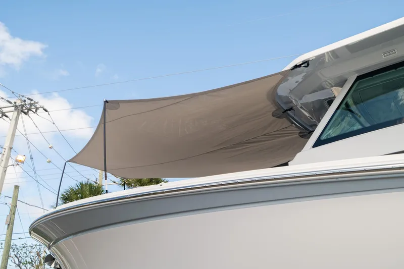 Slide: The Image of 2024 Blackfin 400CC boat with sunshade, viewed from the side under a clear sky. - 13