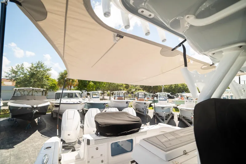 Slide: The Image of 2024 Blackfin 400CC boat displayed outdoors with other boats under a canopy. - 15