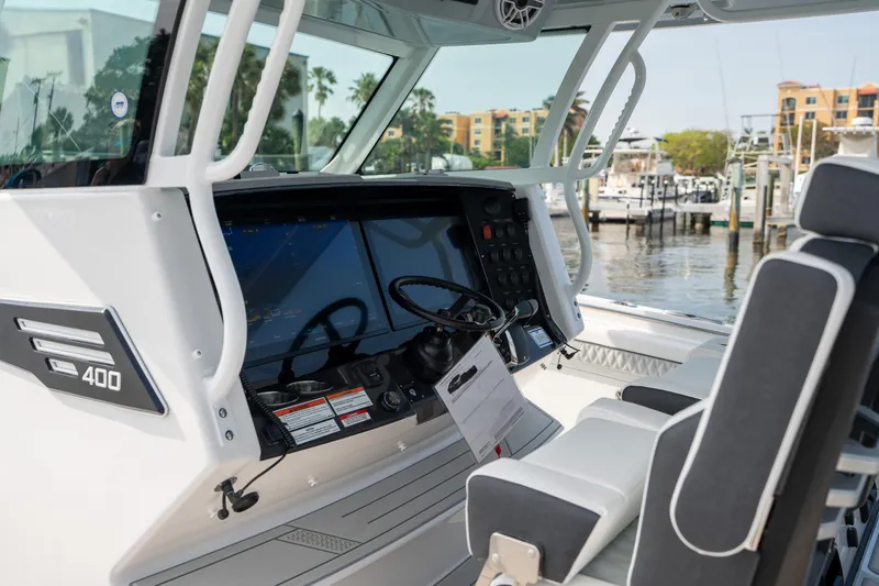 Slide: The Image of 2024 Blackfin 400CC boat cockpit with modern navigation system and comfortable seating. - 17
