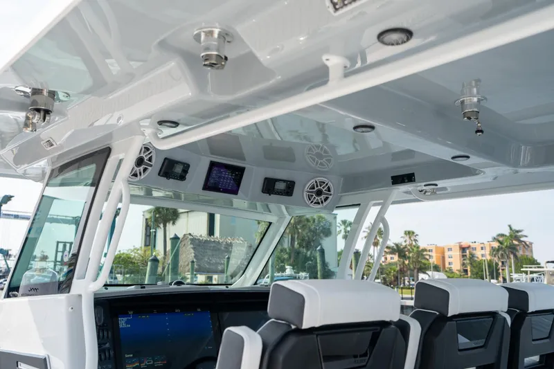 Slide: The Image of Interior view of 2024 Blackfin 400CC boat, featuring modern controls and seating. - 25