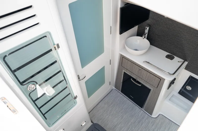 Slide: The Image of 2024 Blackfin 400CC interior with modern bathroom, featuring sink, storage, and sleek design. - 28