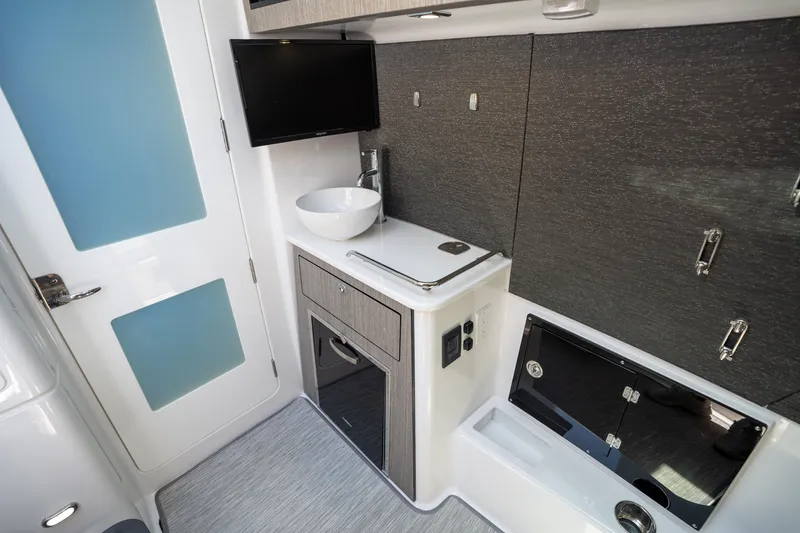 Slide: The Image of 2024 Blackfin 400CC cabin interior with modern amenities, including a sink, TV, and storage cabinets. - 31