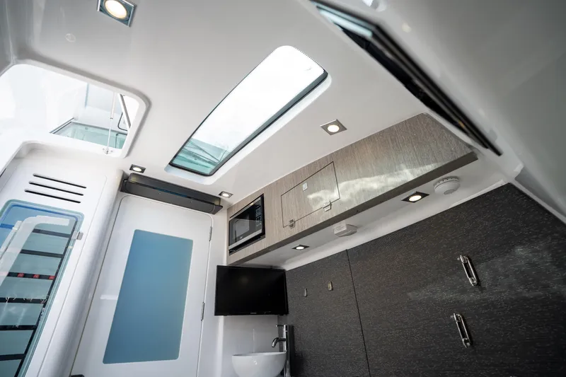 Slide: The Image of Interior of 2024 Blackfin 400CC boat, featuring modern design and sleek cabinetry. - 34