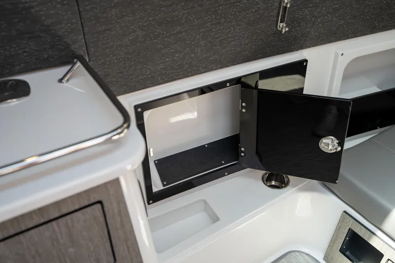 Slide: The Image of 2024 Blackfin 400CC interior storage compartment with open black door, showcasing sleek design. - 36